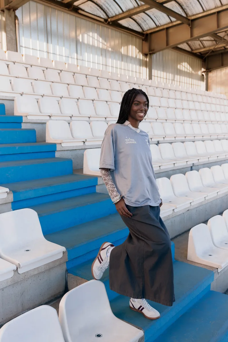 Campaign image with an adapted model in the same stadium setting