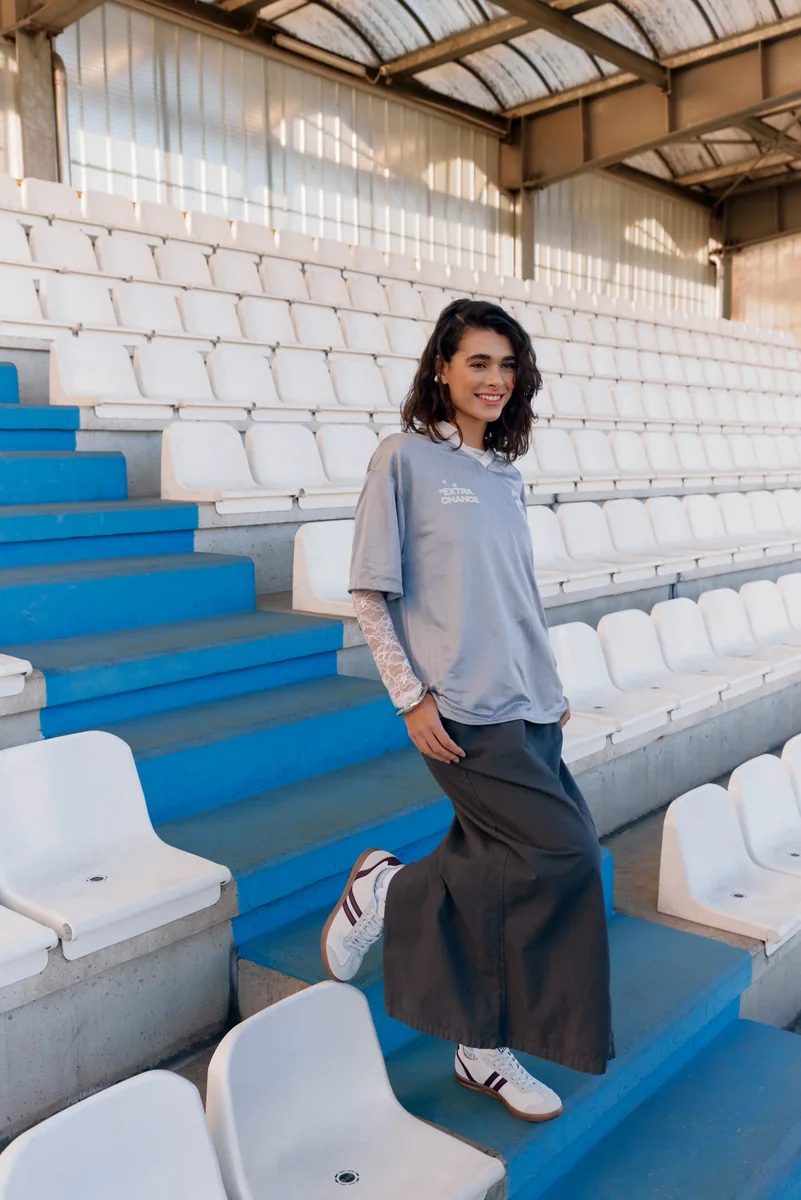 Original campaign model standing on blue stadium steps
